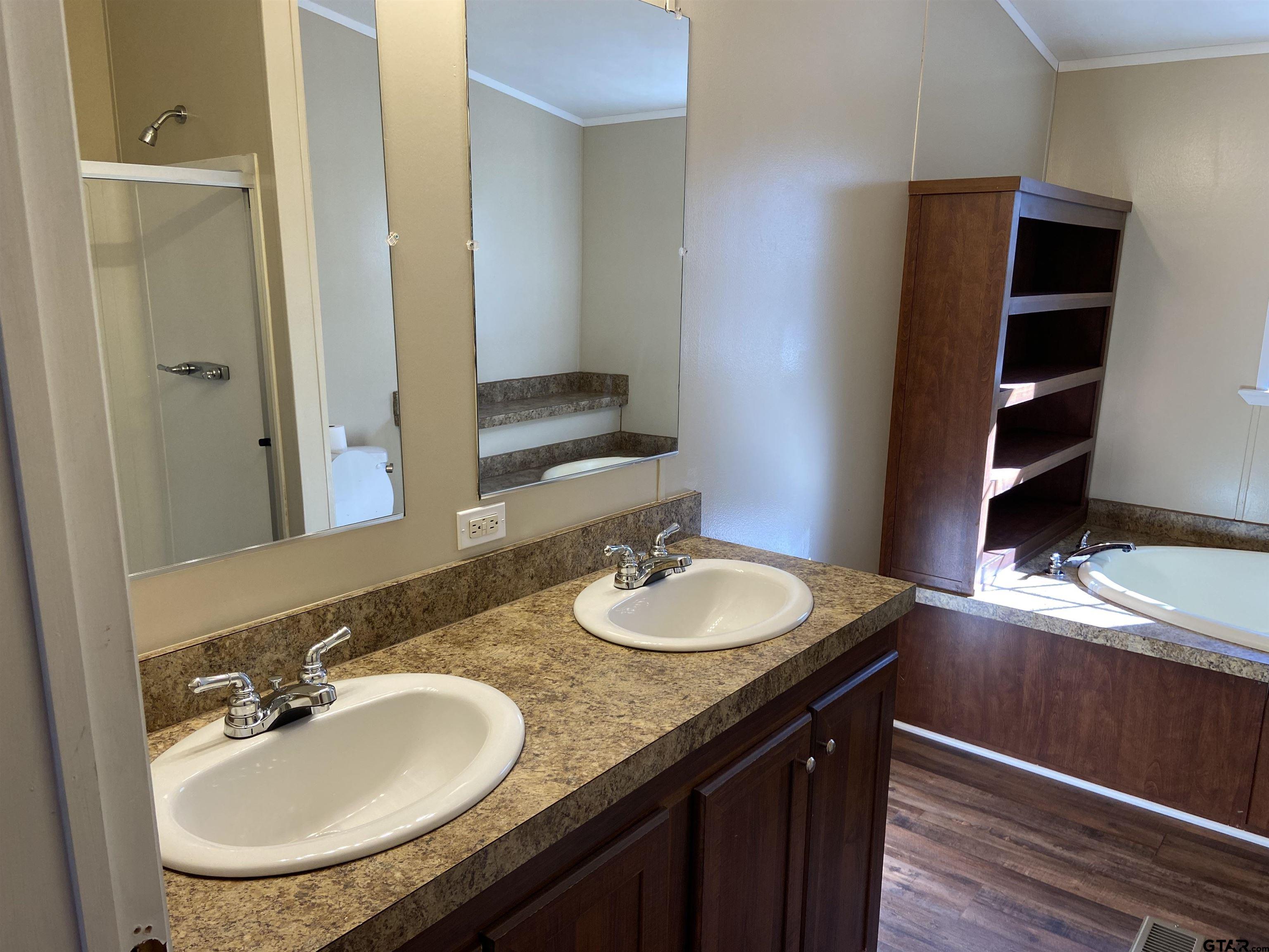 58 Florey Lake Road Kilgore, TX 75662 - Photo 11 of 14 a bathroom with a granite countertop sink and a mirror