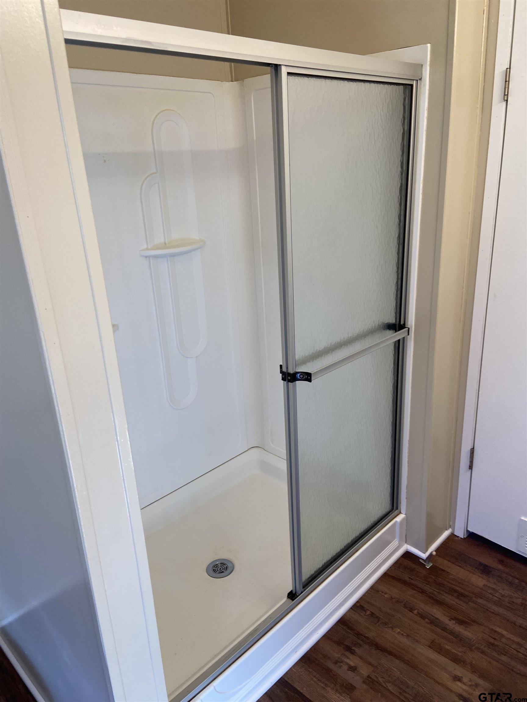 58 Florey Lake Road Kilgore, TX 75662 - Photo 12 of 14 a bathroom with a glass shower door