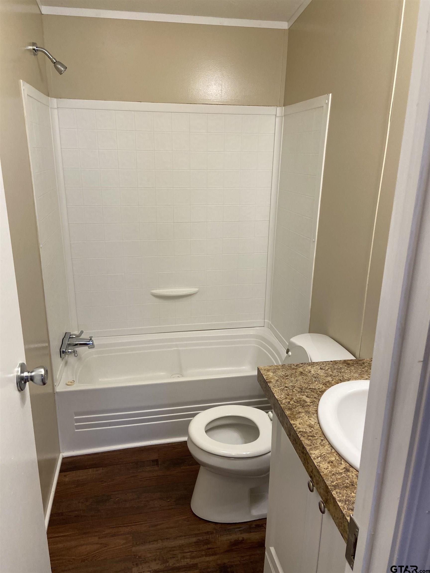 58 Florey Lake Road Kilgore, TX 75662 - Photo 13 of 14 a bathroom with a sink a toilet and shower