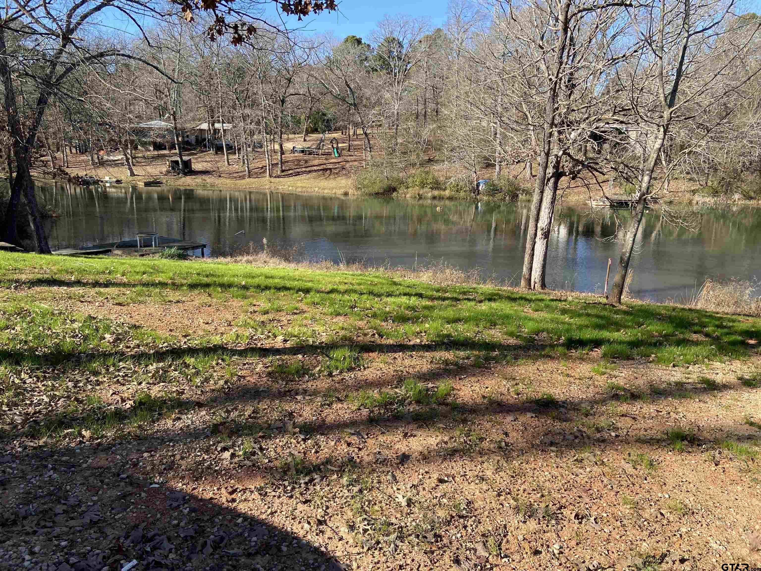 58 Florey Lake Road Kilgore, TX 75662 - Photo 2 of 14 a backyard of a house with a yard and outdoor seating