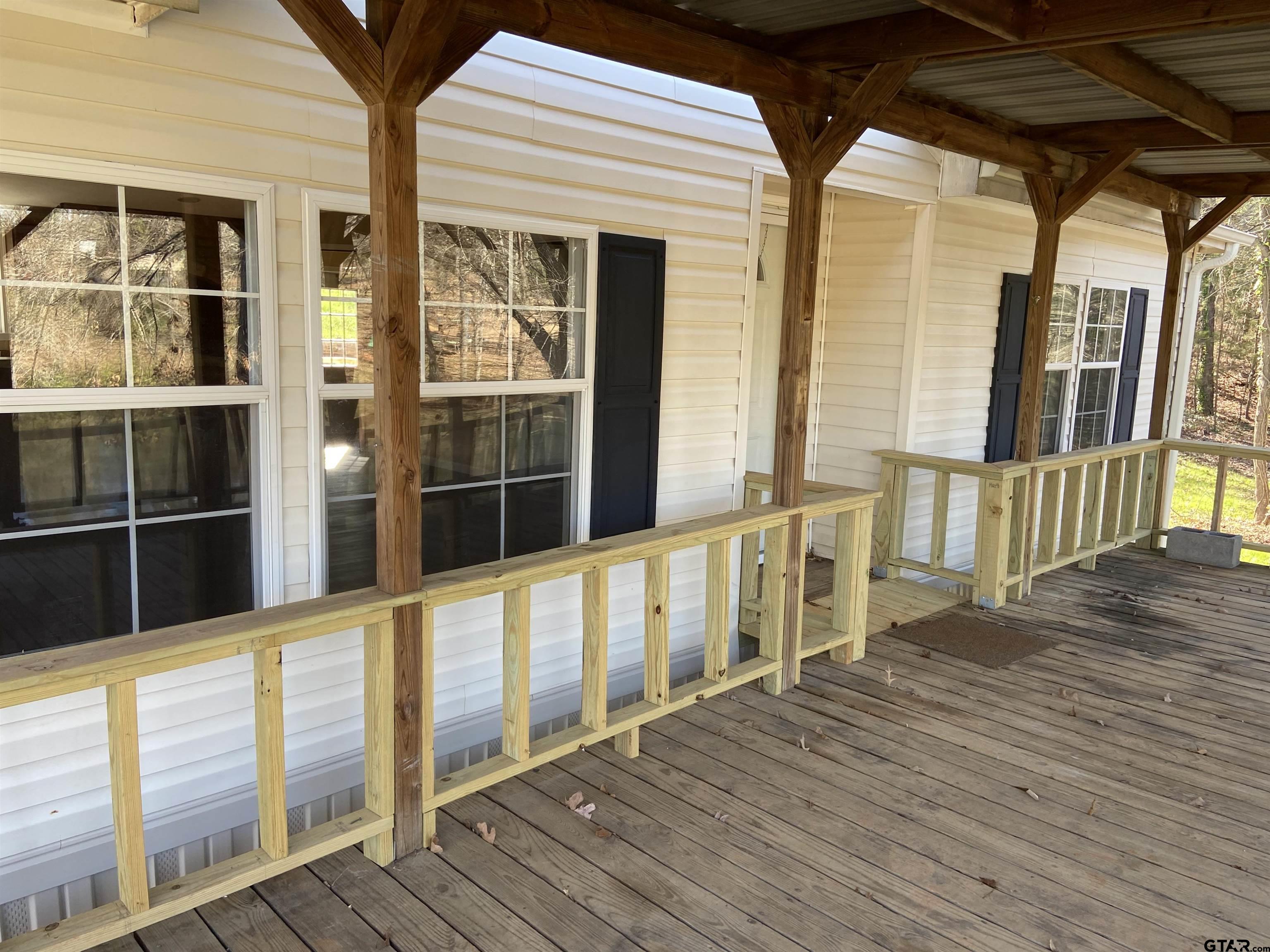 58 Florey Lake Road Kilgore, TX 75662 - Photo 5 of 14 a view of an empty room with wooden floor and windows