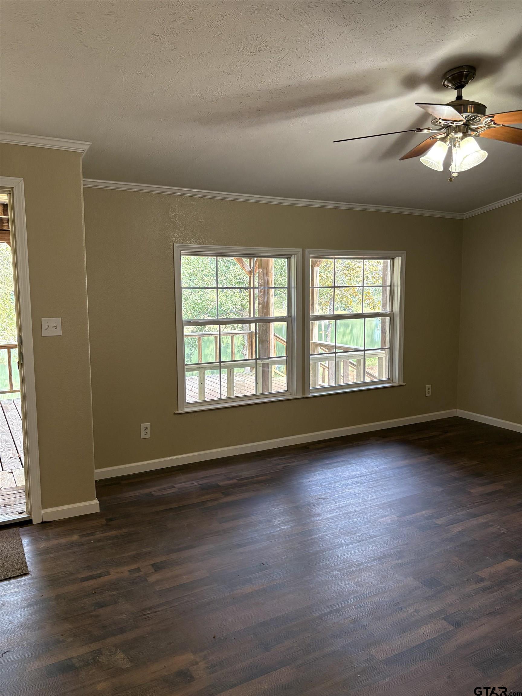 58 Florey Lake Road Kilgore, TX 75662 - Photo 6 of 14 a view of an empty room with wooden floor and a window