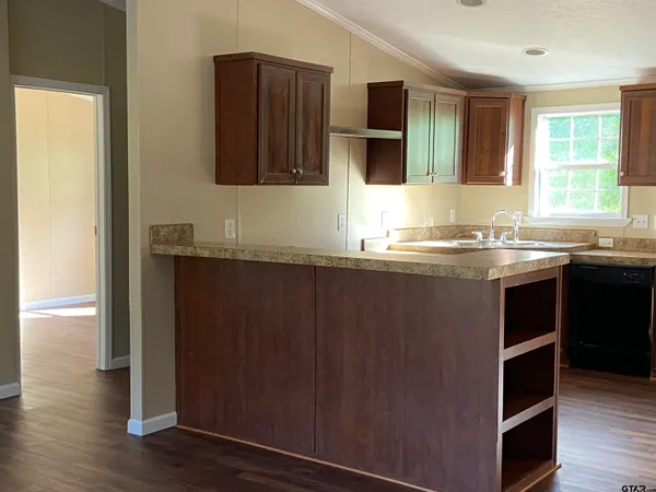 a kitchen with stainless steel appliances granite countertop a sink stove and cabinets