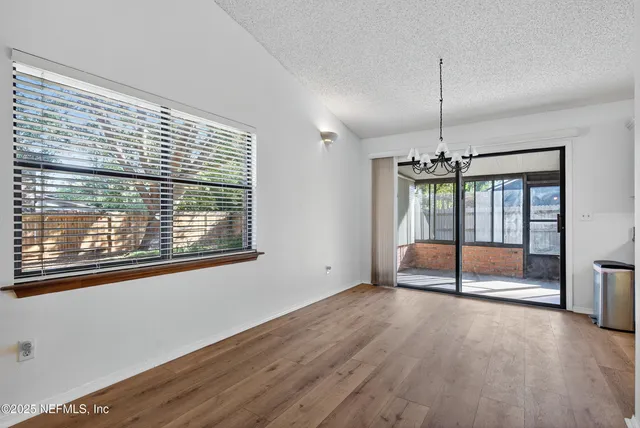 a kitchen with stainless steel appliances granite countertop a sink a stove a refrigerator and cabinets