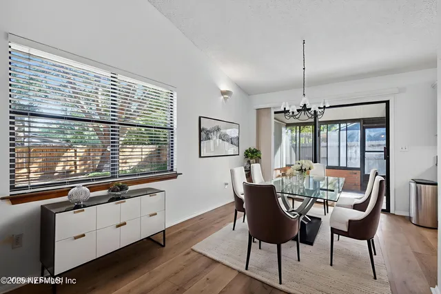 a kitchen with granite countertop a sink stainless steel appliances and white cabinets