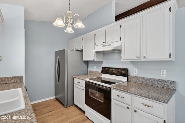 a view of a big room with wooden floor closet and windows