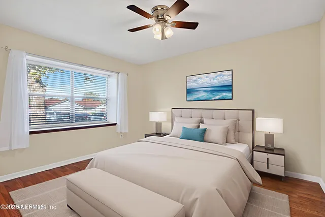 a bedroom with a large bed and a flat tv screen