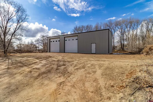 a view of a house with a snow in front of yard