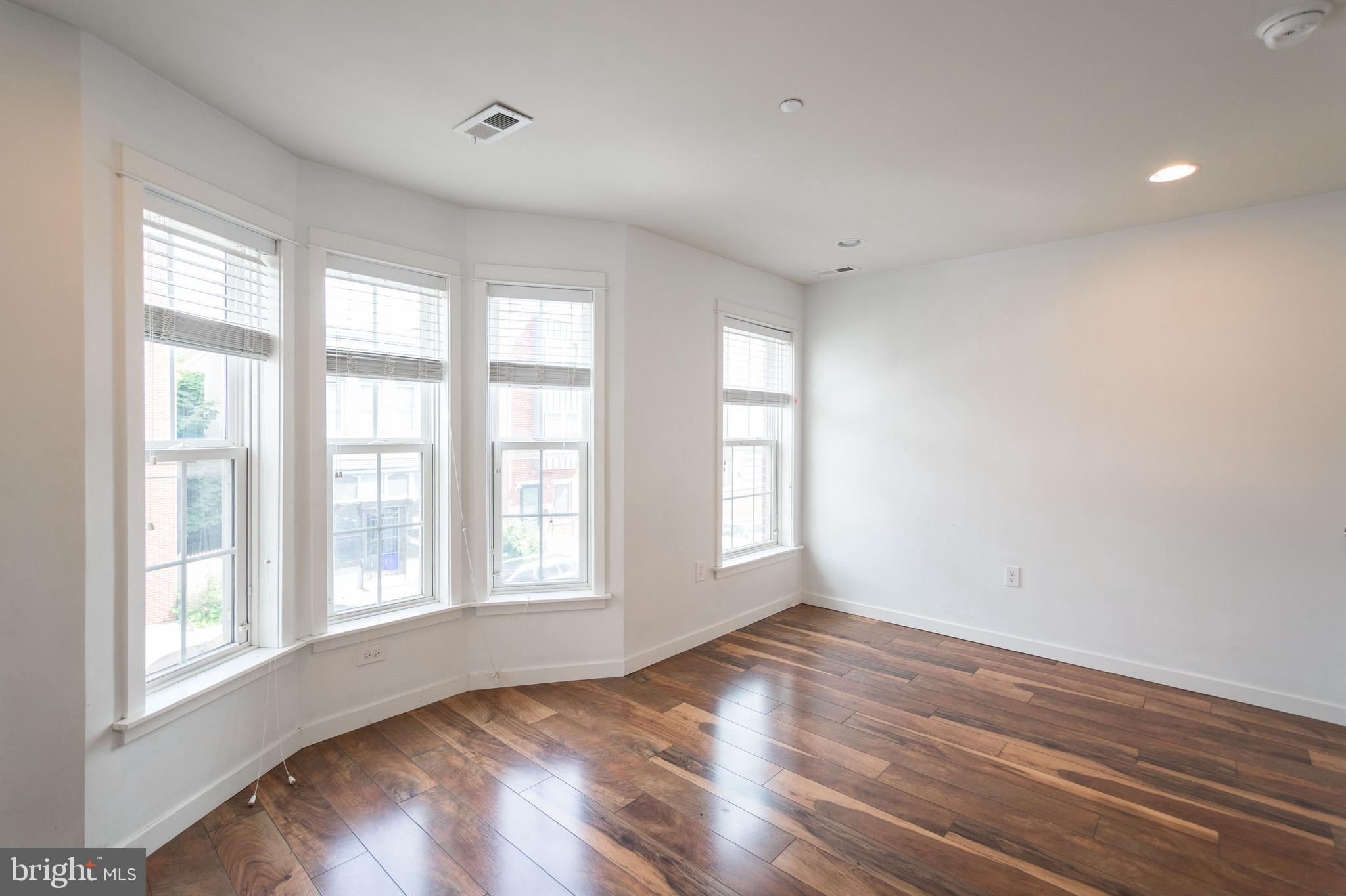 132 South 46th Street, Unit B Philadelphia, PA 19139 - Photo 12 of 15 a view of an empty room with wooden floor and a window