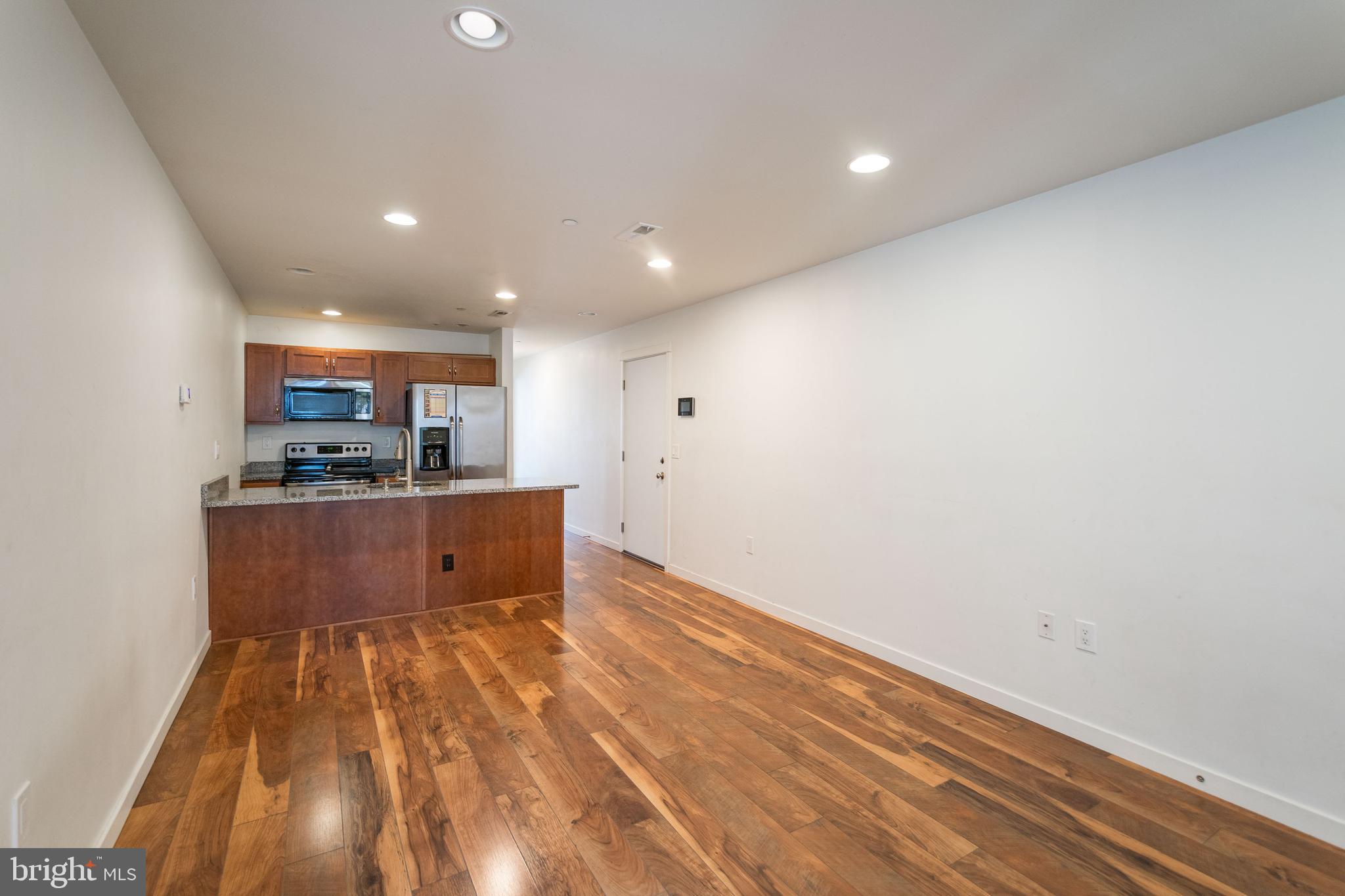 132 South 46th Street, Unit B Philadelphia, PA 19139 - Photo 3 of 15 a view of kitchen with cabinets and wooden floor