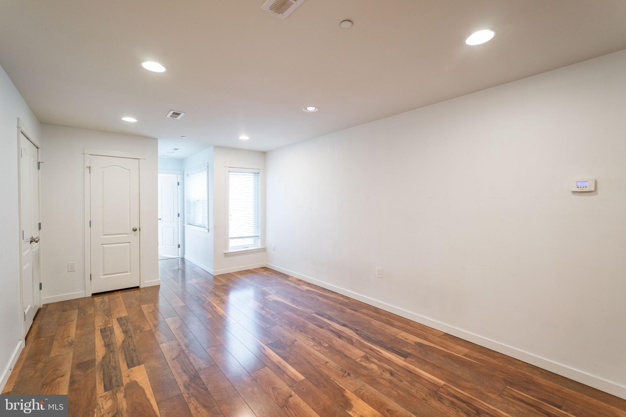 132 South 46th Street, Unit B Philadelphia, PA 19139 - Photo 4 of 15 a view of an empty room with wooden floor and closet