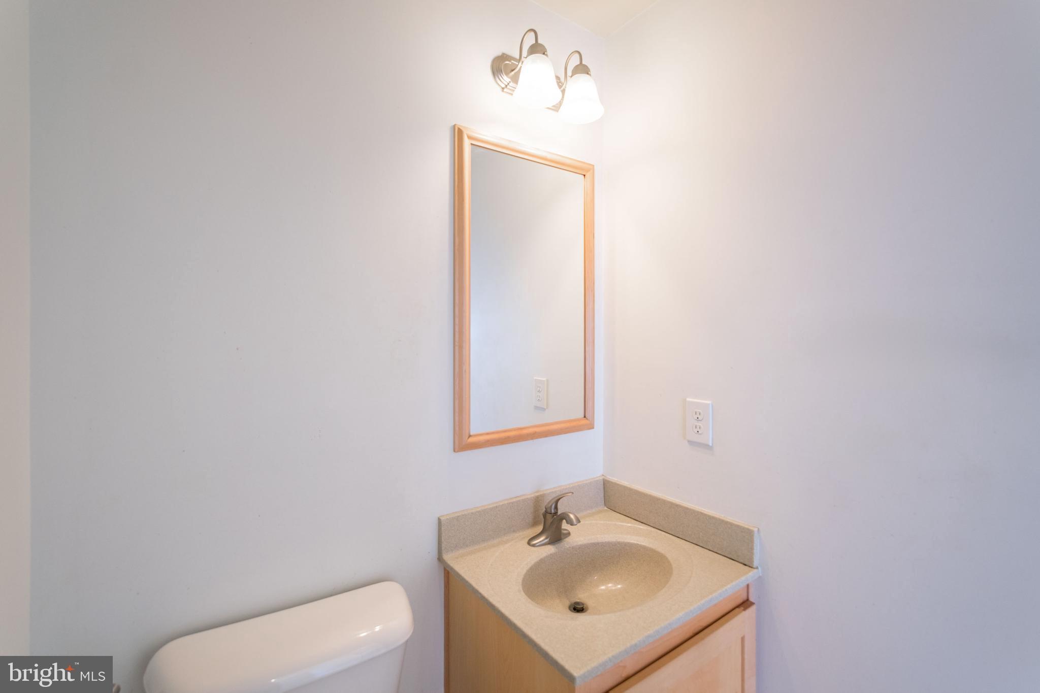 132 South 46th Street, Unit B Philadelphia, PA 19139 - Photo 8 of 15 a bathroom with a toilet sink and mirror