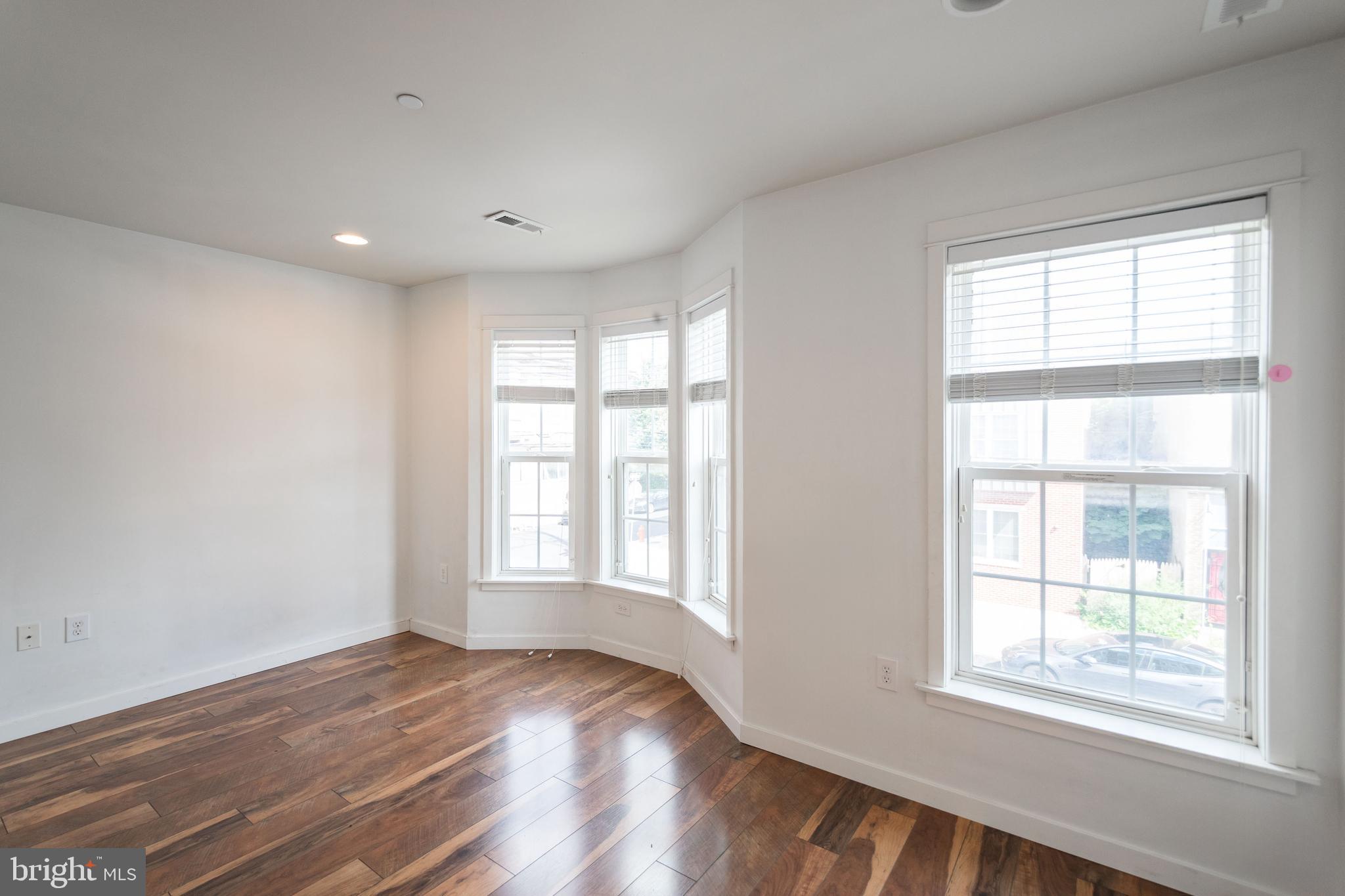 132 South 46th Street, Unit B Philadelphia, PA 19139 - Photo 10 of 15 a view of an empty room with wooden floor and a window