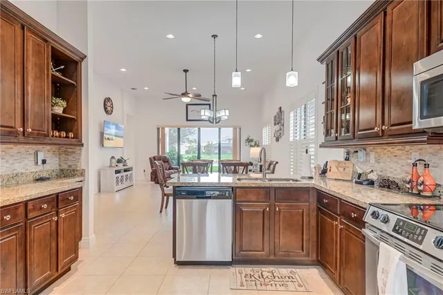 a kitchen with lots of counter top space appliances and cabinets