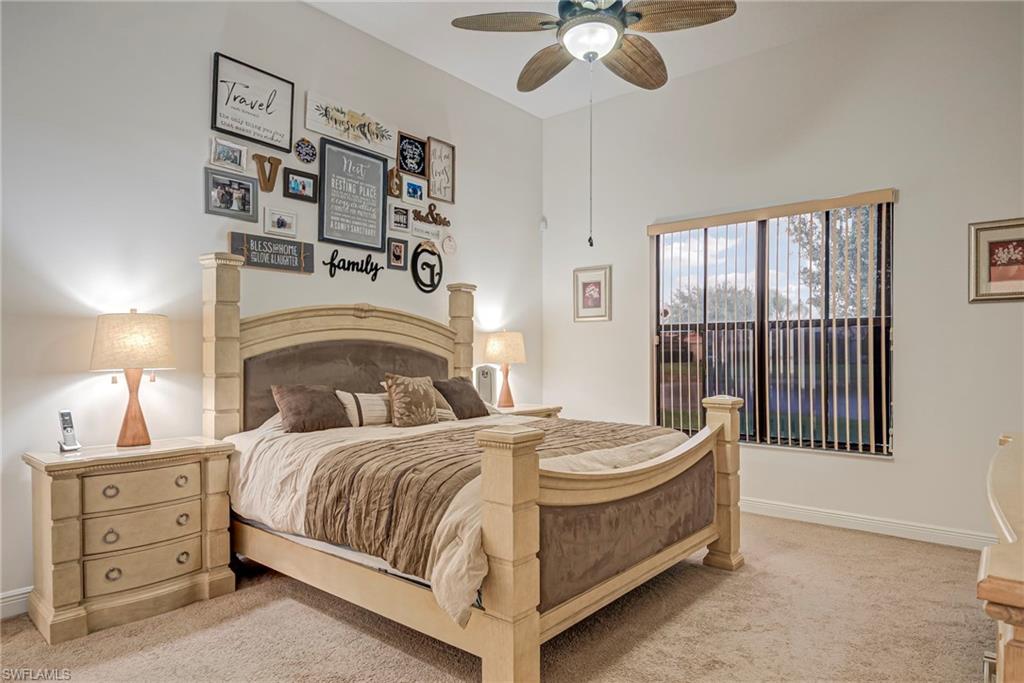 5239 Ferrari Avenue Ave Maria, FL 34142 - Photo 13 of 30 a bedroom with a bed and a chandelier