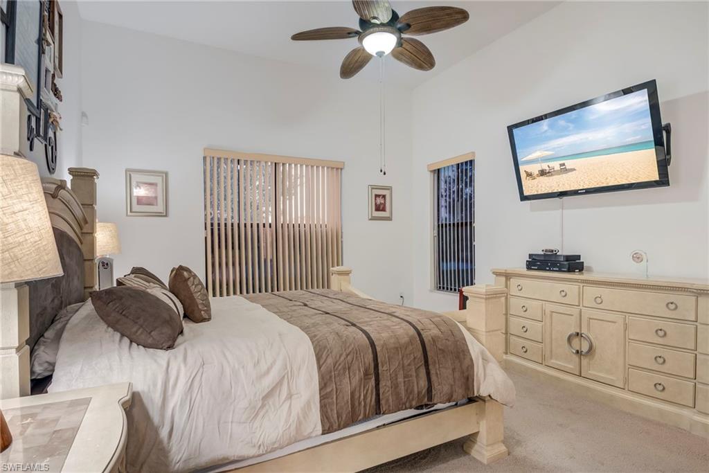 5239 Ferrari Avenue Ave Maria, FL 34142 - Photo 14 of 30 a bedroom with a bed and a flat tv screen