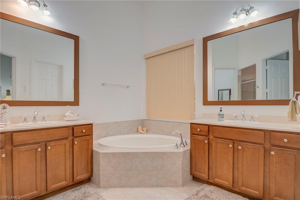 5239 Ferrari Avenue Ave Maria, FL 34142 - Photo 16 of 30 a bathroom with a sink and a mirror