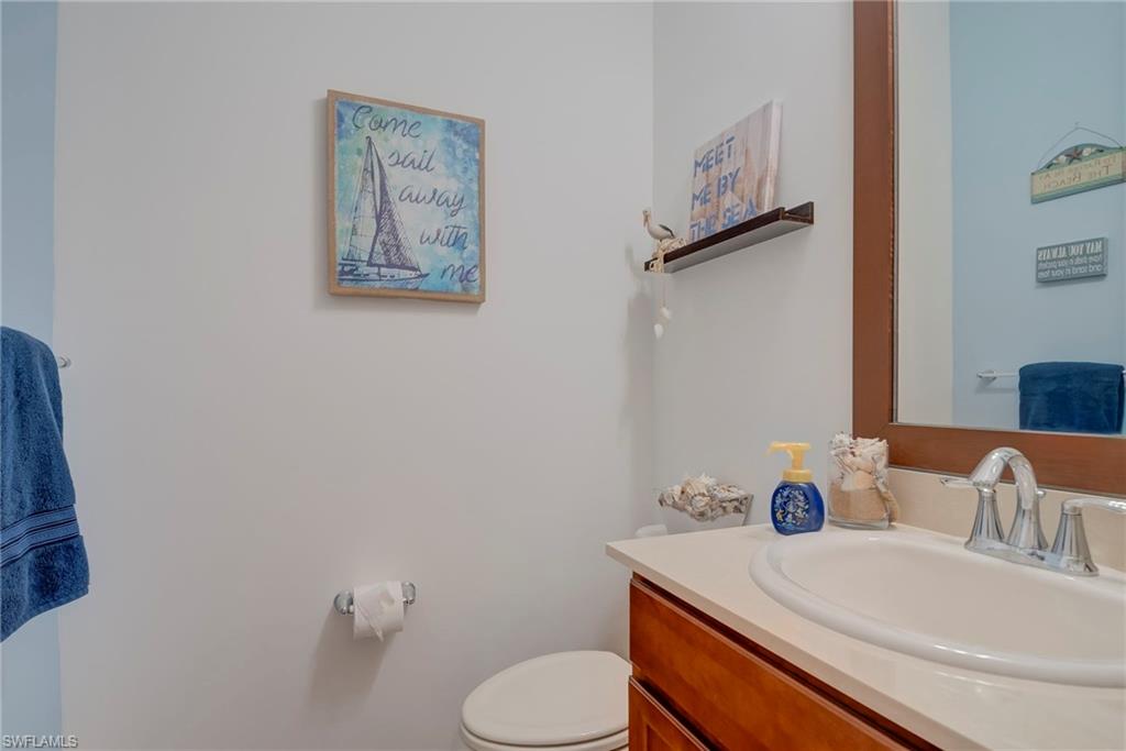 5239 Ferrari Avenue Ave Maria, FL 34142 - Photo 18 of 30 a bathroom with a toilet sink and mirror