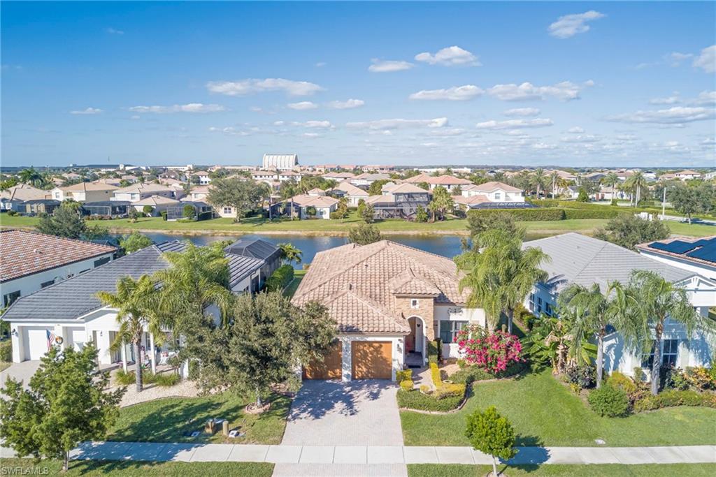 5239 Ferrari Avenue Ave Maria, FL 34142 - Photo 2 of 30 an aerial view of ocean residential house with outdoor space and seating