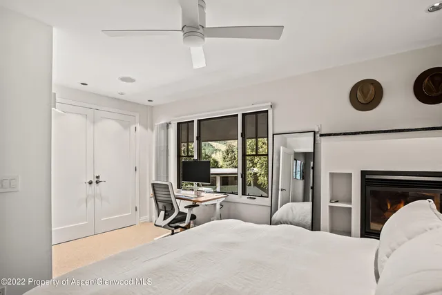 a bedroom with a bed and a table