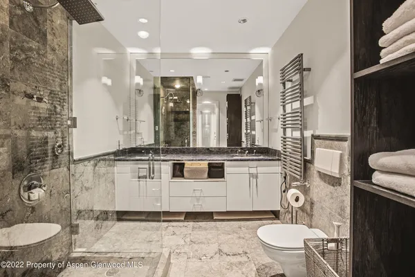 a bathroom with a sink toilet a mirror and shower