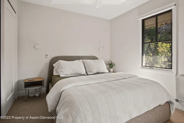 a bedroom with a bed and a window