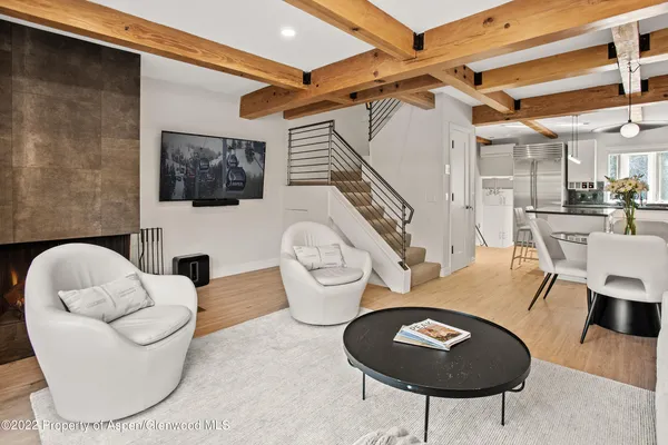 a living room with furniture a flat screen tv and rug