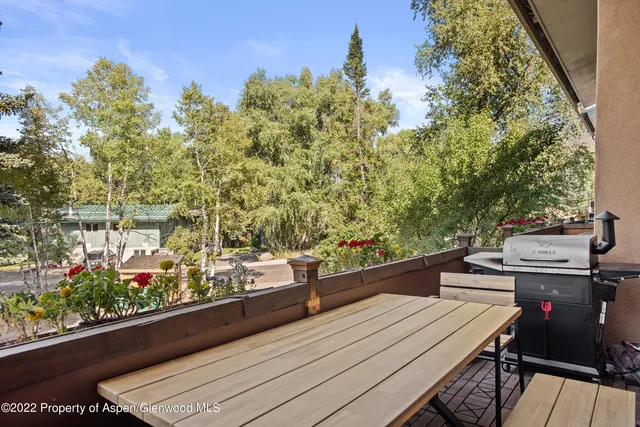 a view of a balcony with two chairs and a table