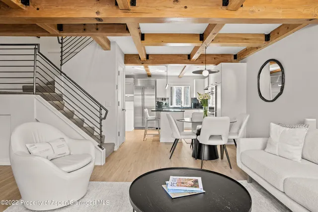 a living room with furniture and a clock