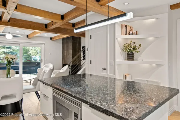 a view of a kitchen filled with furniture and a window
