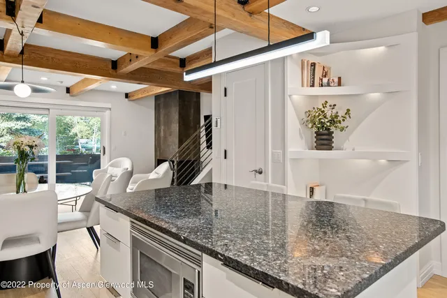 a view of a kitchen filled with furniture and a window