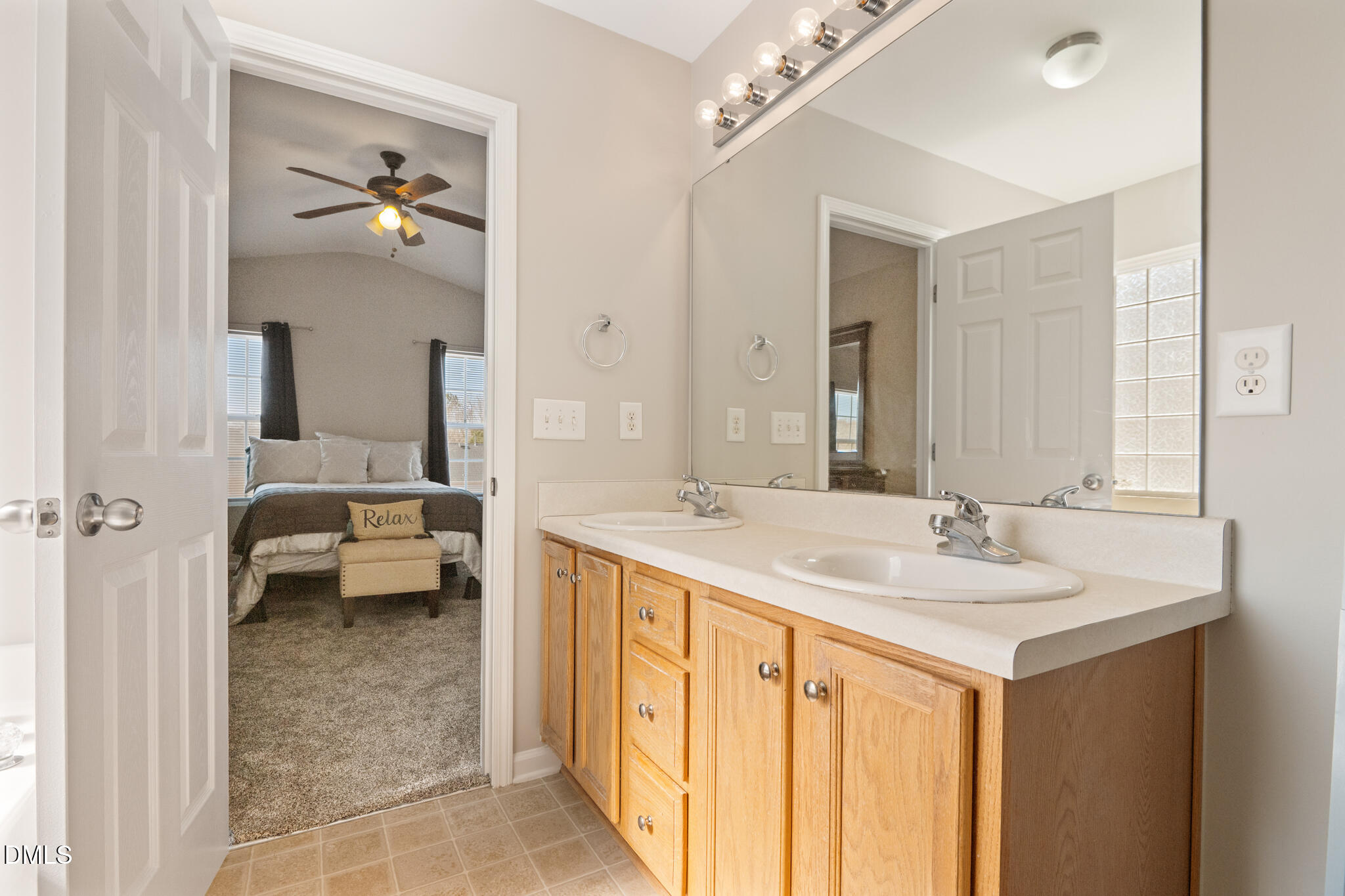 2019 Tennessee Road Durham, NC 27704 - Photo 19 of 28 a en suite bathroom with a sink a mirror and a shower