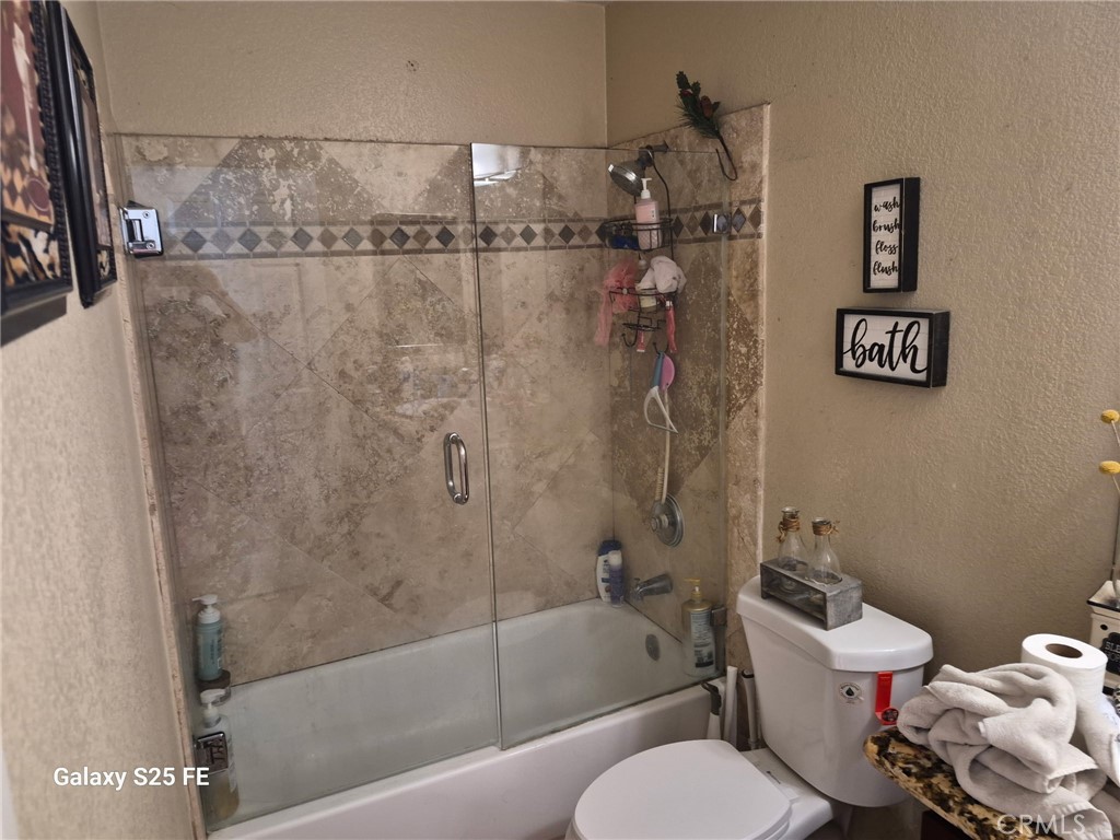 2282 North Smoketree Avenue Rialto, CA 92377 - Photo 15 of 15 a bathroom with a bathtub and shower