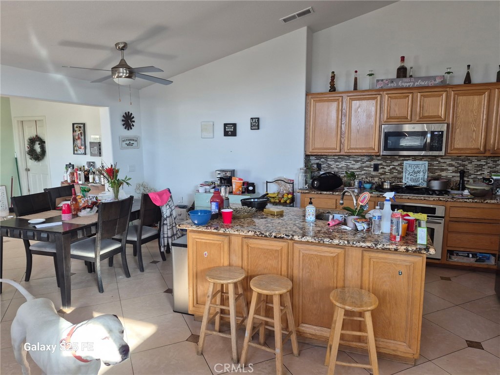 2282 North Smoketree Avenue Rialto, CA 92377 - Photo 3 of 15 a kitchen with a dining table and chairs