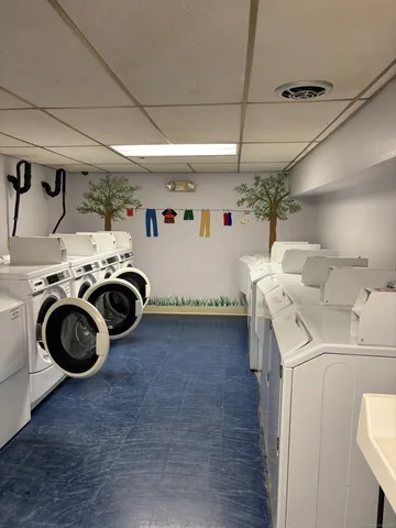 a utility room with sink dryer and washer