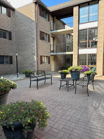 a view of a patio with table and chairs and potted plants