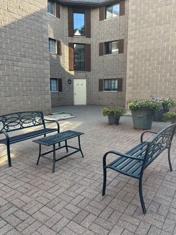 a building outdoor space with a couch and a potted plant