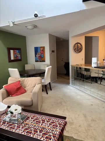 a living room with furniture rug and window