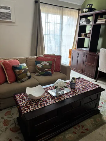 a living room with furniture fireplace and window