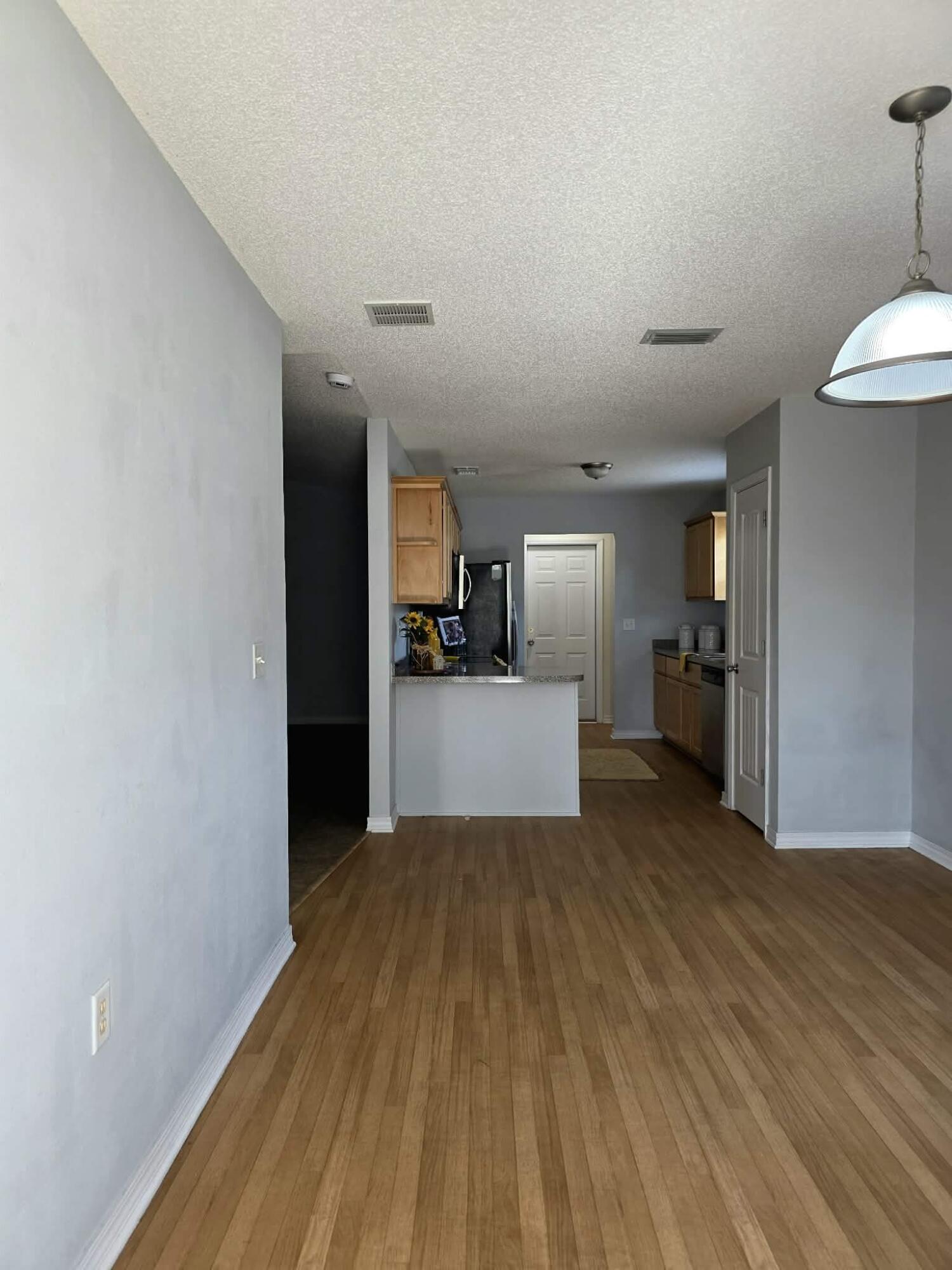 8347 Tavira Street Navarre, FL 32566 - Photo 11 of 49 a view of a kitchen with a sink and a refrigerator