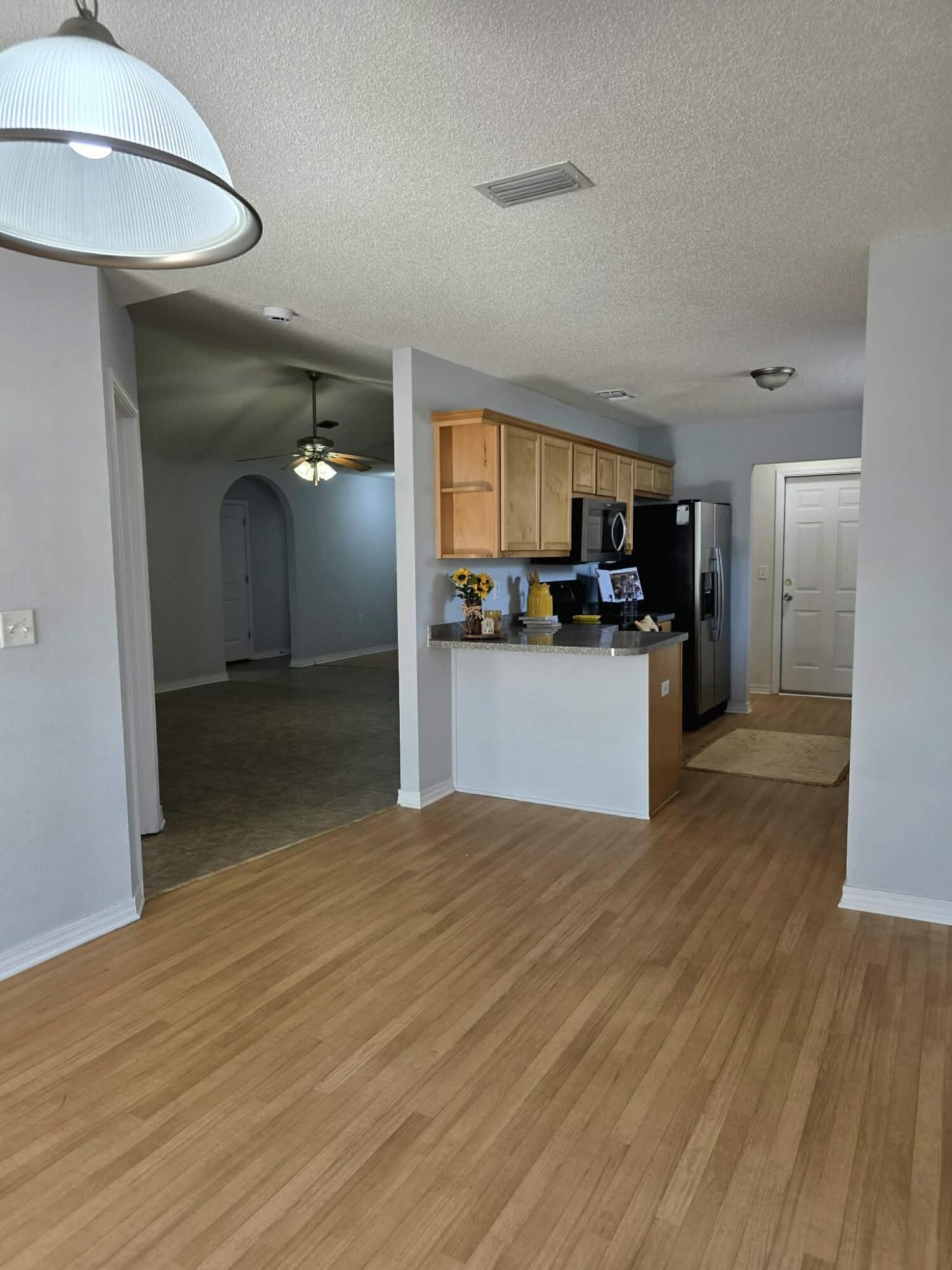 8347 Tavira Street Navarre, FL 32566 - Photo 12 of 49 a view of a kitchen cabinets and wooden floor