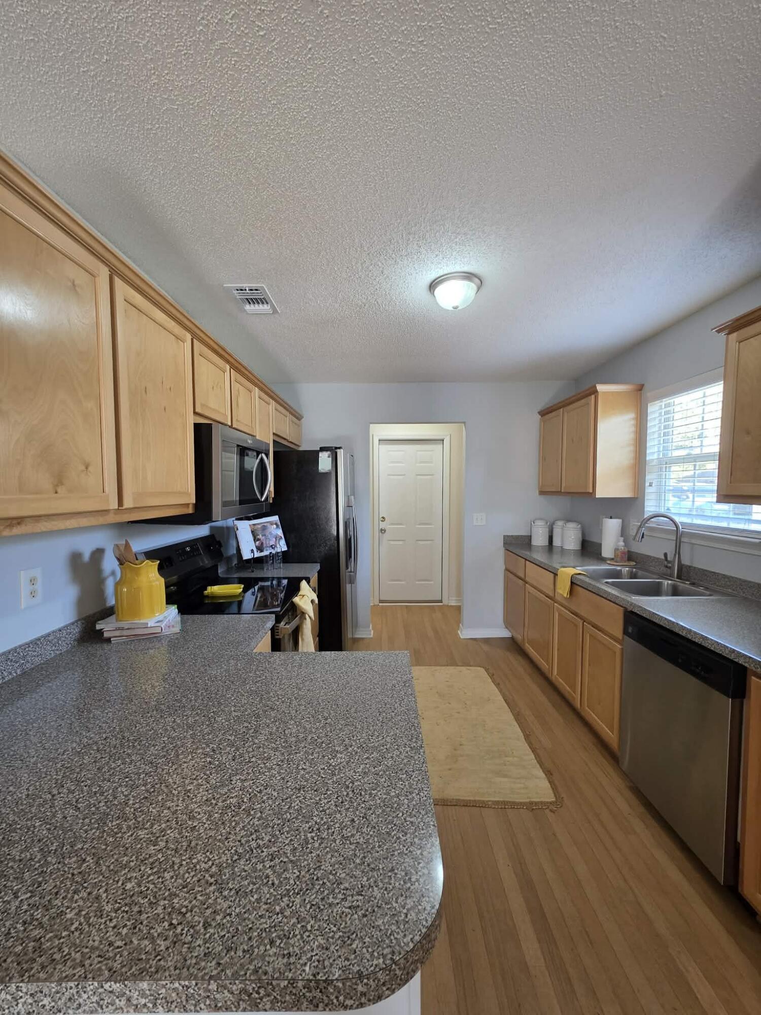 8347 Tavira Street Navarre, FL 32566 - Photo 13 of 49 a large kitchen with a lot of counter space and a sink