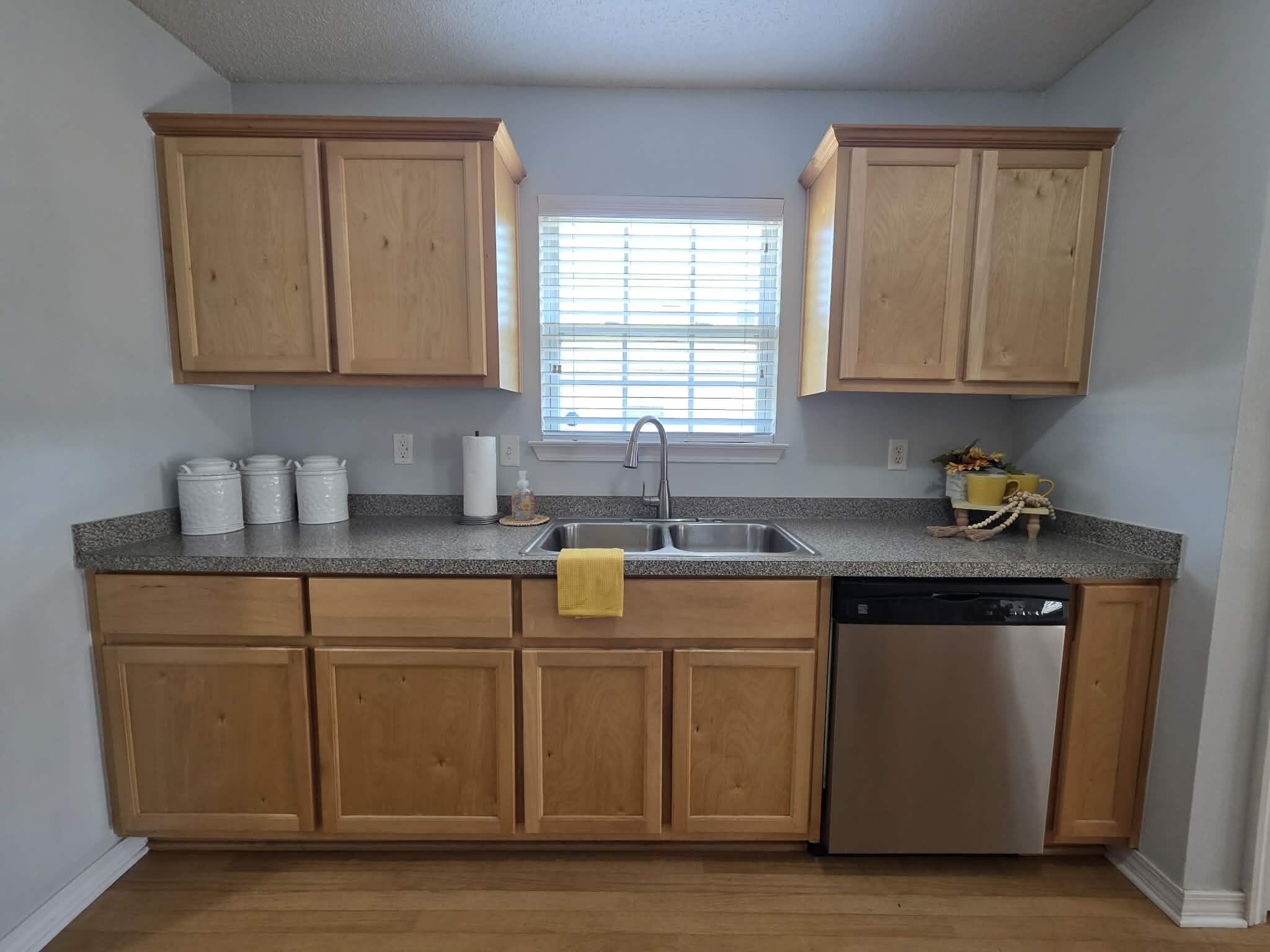 8347 Tavira Street Navarre, FL 32566 - Photo 19 of 49 a kitchen with stainless steel appliances granite countertop a sink stove and cabinets
