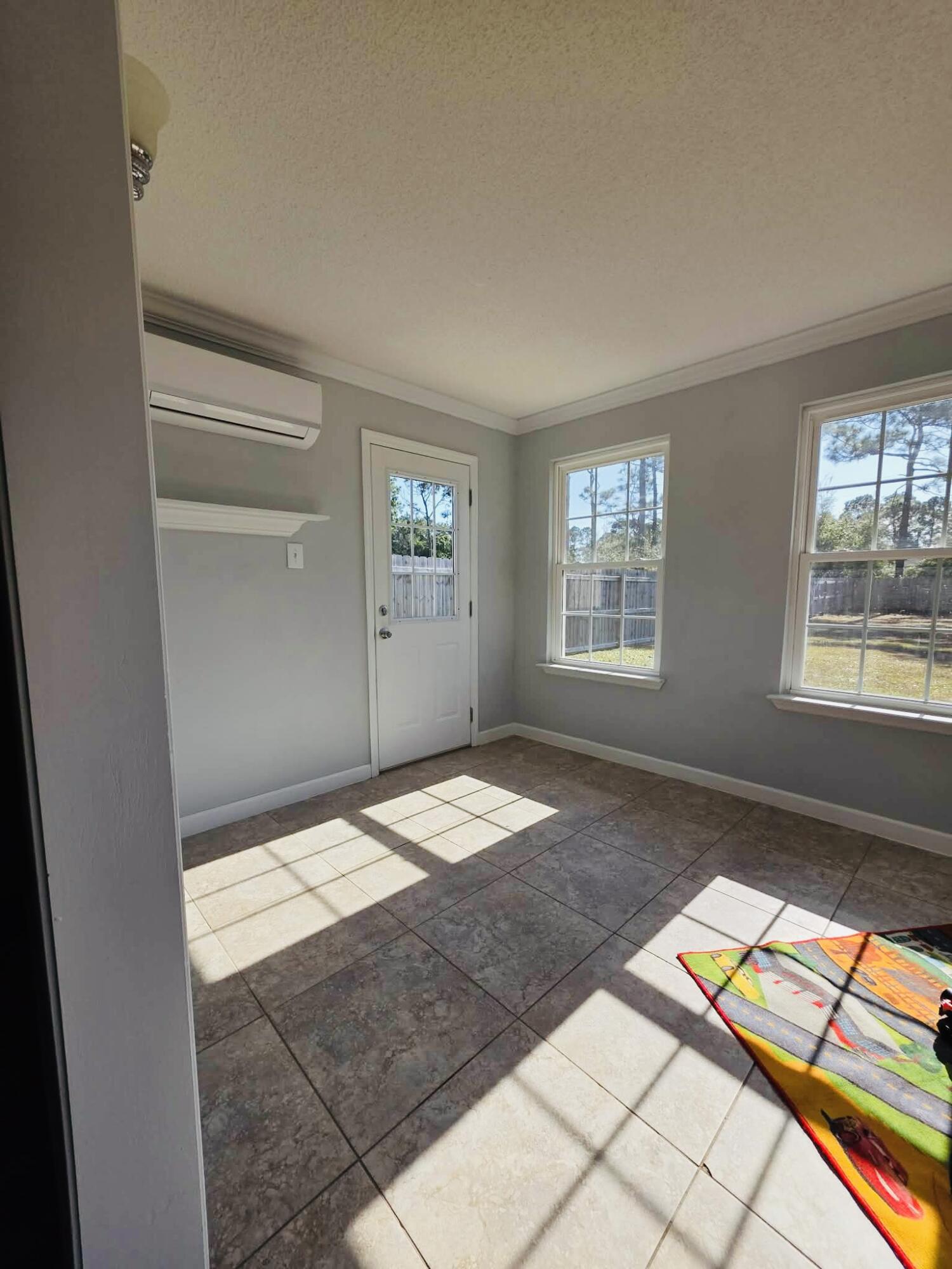 8347 Tavira Street Navarre, FL 32566 - Photo 23 of 49 a bedroom with a bed and a window