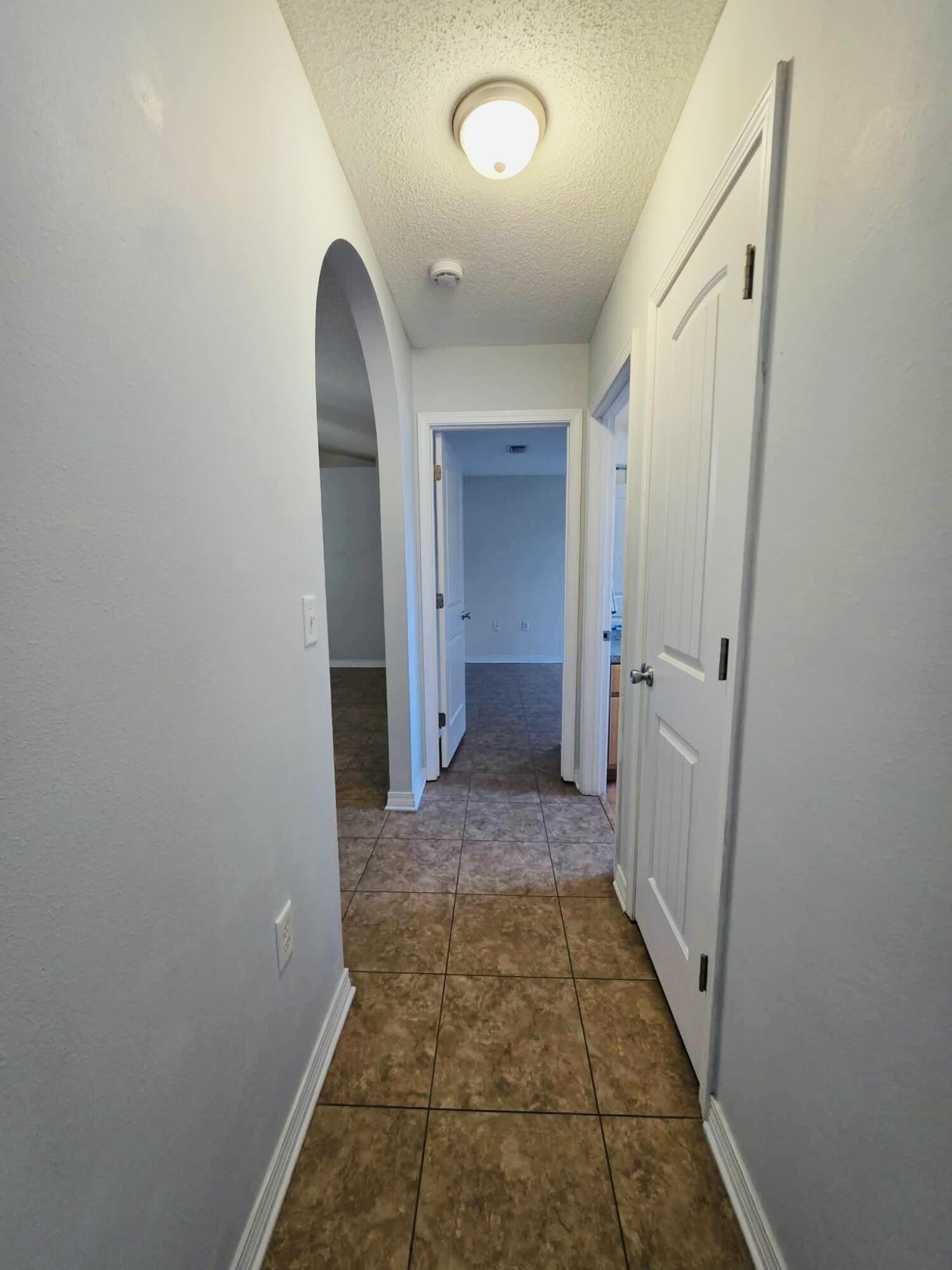 8347 Tavira Street Navarre, FL 32566 - Photo 26 of 49 a view of a bathroom from a hallway