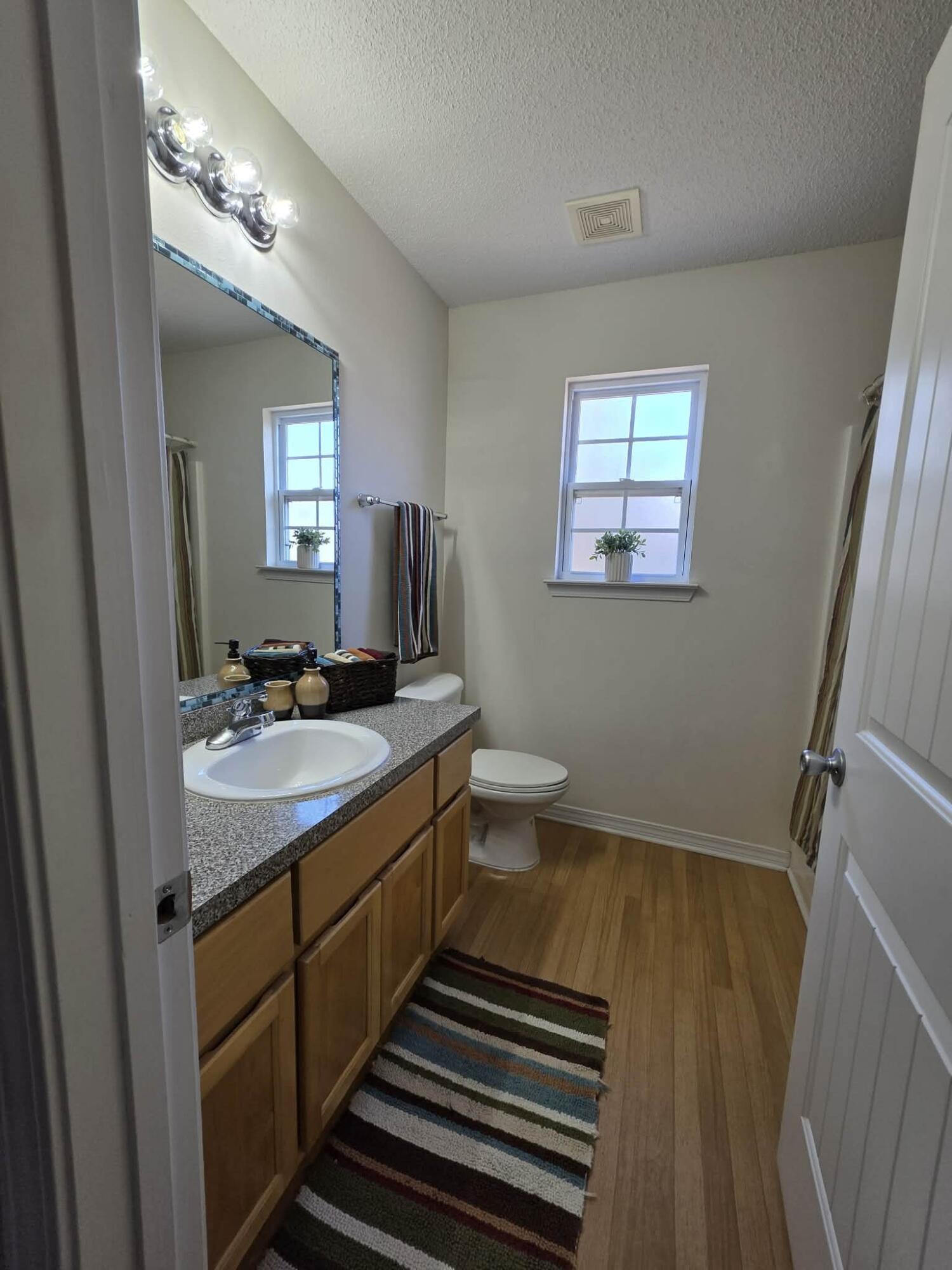 8347 Tavira Street Navarre, FL 32566 - Photo 28 of 49 a bathroom with a double vanity sink and a mirror