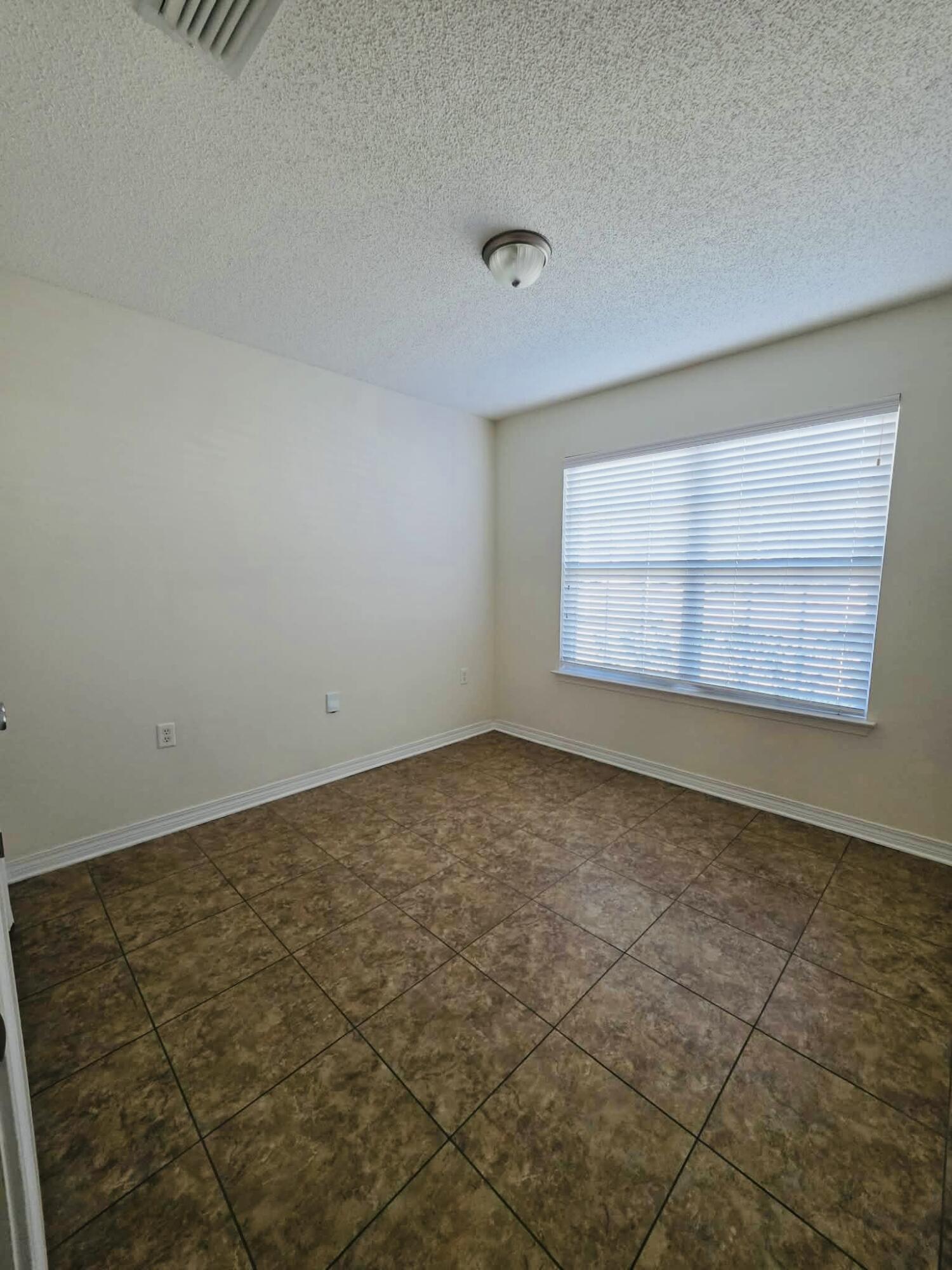8347 Tavira Street Navarre, FL 32566 - Photo 32 of 49 an empty room with a empty space and window