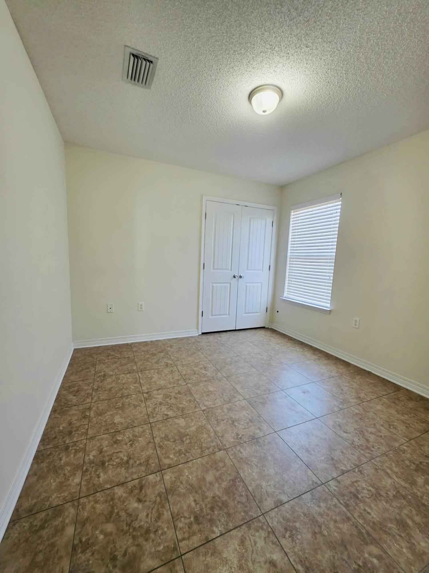 8347 Tavira Street Navarre, FL 32566 - Photo 33 of 49 an empty room with a natural light