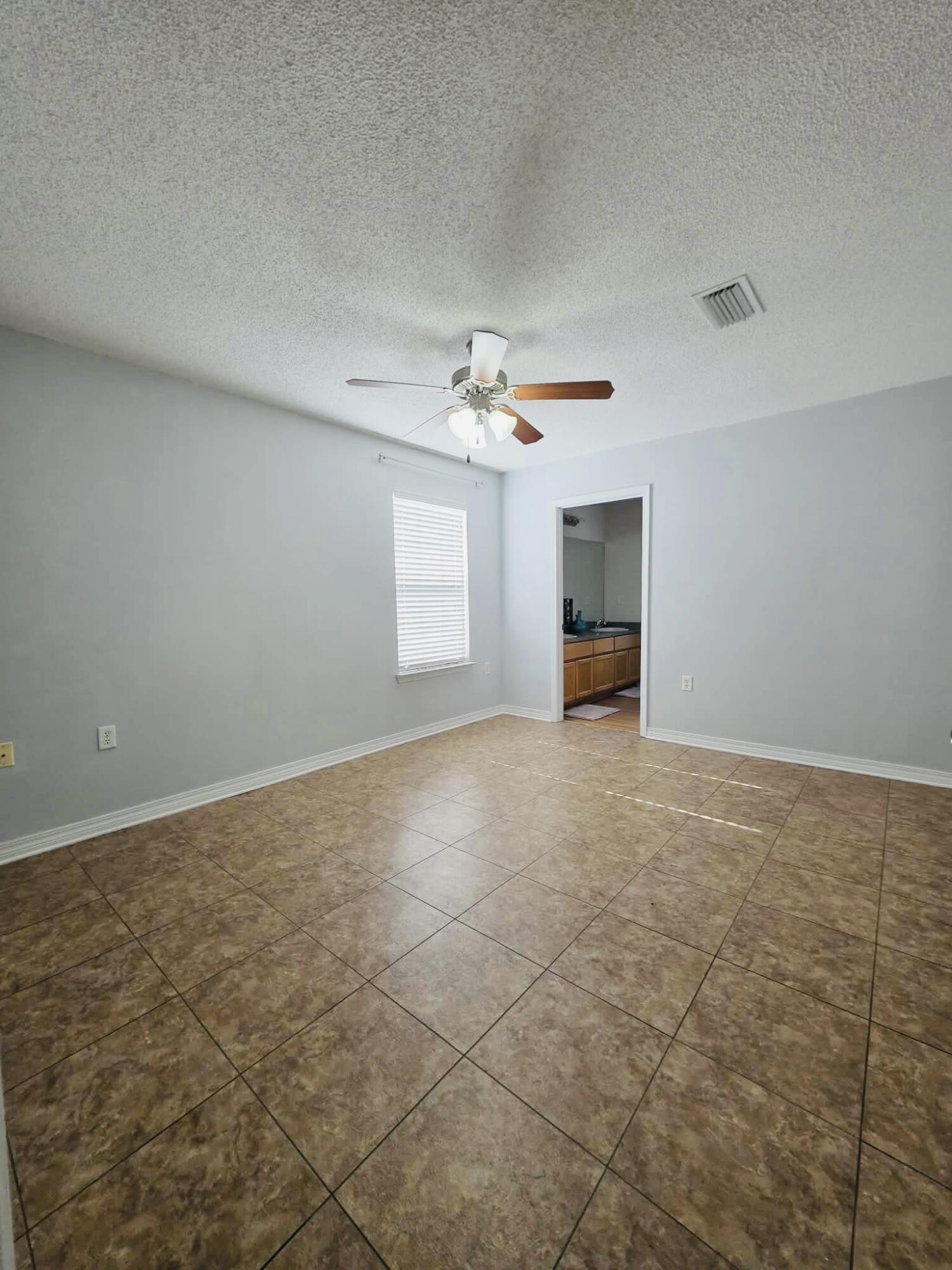 8347 Tavira Street Navarre, FL 32566 - Photo 34 of 49 an empty room with windows and entrance