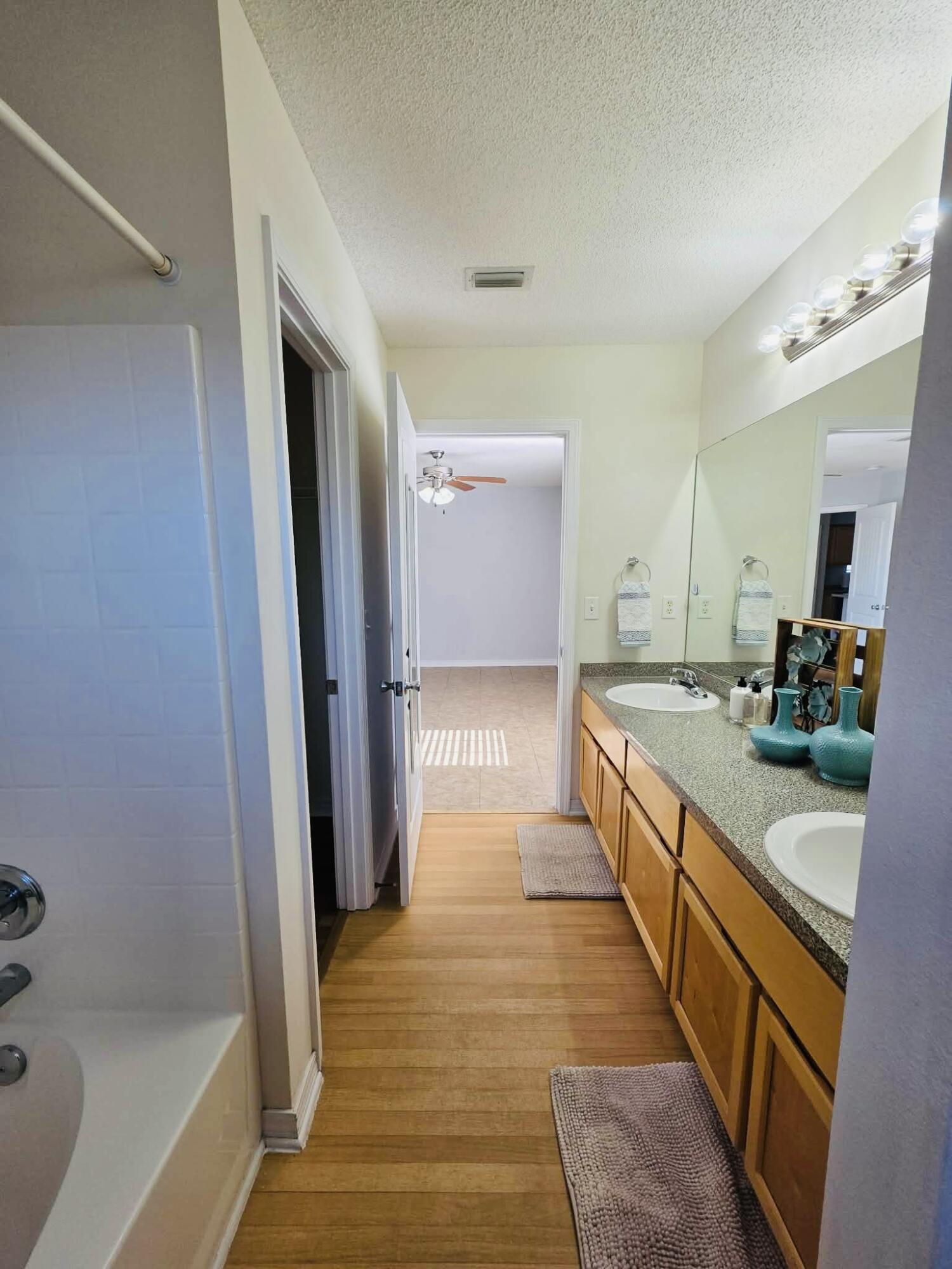 8347 Tavira Street Navarre, FL 32566 - Photo 38 of 49 a large bathroom with a tub and shower